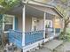 House exterior featuring a covered porch with blue railings and landscaping at 108 W 650 South, Pendleton, IN 46064