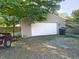 Detached garage with white door and gravel driveway at 108 W 650 South, Pendleton, IN 46064