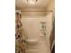 Clean bathroom with shower/tub combo, built-in shelves, and colorful shower curtain at 108 W 650 South, Pendleton, IN 46064