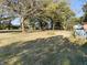 Spacious backyard with mature trees and partial fence at 108 W 650 South, Pendleton, IN 46064