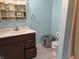 Bathroom with vanity, toilet, and shower in a light teal room at 108 W 650 South, Pendleton, IN 46064