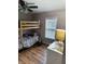 Bedroom with bunk beds, a window with blinds, and laminate wood flooring at 108 W 650 South, Pendleton, IN 46064