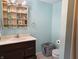 Bathroom with vanity, toilet, and shower in a light teal room at 108 W 650 South, Pendleton, IN 46064