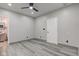 Simple bedroom with grey walls, ceiling fan, and access to a full bathroom at 1245 N Mount St, Indianapolis, IN 46222