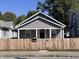 Front view of charming bungalow with gray siding and wooden fence at 1245 N Mount St, Indianapolis, IN 46222