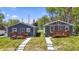 Two charming gray homes with wooden decks and landscaping at 3006 N Olney St, Indianapolis, IN 46218