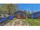 Grey house with wooden deck and parked cars at 3006 N Olney St, Indianapolis, IN 46218