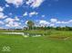 Scenic community pond with lush landscaping and walking paths at 6272 Wasco Dr, Whitestown, IN 46075