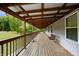 Long wooden porch with wooden swing and view of backyard at 5724 N Blazing Star Rd, Monrovia, IN 46157