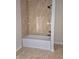 Bathroom with a bathtub and shower, marble-look tile at 525 Schmitt Rd, Indianapolis, IN 46239