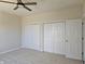Spacious bedroom with double door closets and ceiling fan at 525 Schmitt Rd, Indianapolis, IN 46239