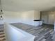 Bright bonus room with gray wood-look floors and a wet bar at 525 Schmitt Rd, Indianapolis, IN 46239
