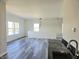 Bonus room with gray wood-look floors, a wet bar, and multiple windows at 525 Schmitt Rd, Indianapolis, IN 46239