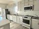 Modern kitchen with gray cabinets and marble backsplash at 525 Schmitt Rd, Indianapolis, IN 46239