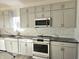 Modern kitchen with gray cabinets and marble backsplash at 525 Schmitt Rd, Indianapolis, IN 46239