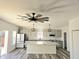 Modern kitchen with island, stainless steel appliances, and gray cabinets at 525 Schmitt Rd, Indianapolis, IN 46239