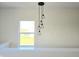 Open landing with a chandelier and large window overlooking the backyard at 525 Schmitt Rd, Indianapolis, IN 46239