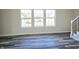 Living room with gray wood-look floors and large windows at 525 Schmitt Rd, Indianapolis, IN 46239