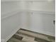 Empty pantry with white shelves and wood-look flooring at 525 Schmitt Rd, Indianapolis, IN 46239