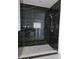 Elegant shower with black marble tile and a rain shower head at 525 Schmitt Rd, Indianapolis, IN 46239