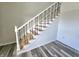 Elegant staircase with wood steps and wrought iron railing at 525 Schmitt Rd, Indianapolis, IN 46239