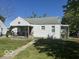 White house with a covered porch and a manicured lawn at 616 W 38Th St, Anderson, IN 46013