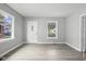 Bright living room featuring hardwood floors and large windows at 1472 N Grant Ave, Indianapolis, IN 46201