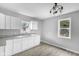 Modern kitchen with white cabinets and granite countertops at 1472 N Grant Ave, Indianapolis, IN 46201
