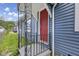 House exterior featuring a red door and blue siding at 1472 N Grant Ave, Indianapolis, IN 46201