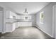 Modern kitchen with white cabinets and grey flooring at 1472 N Grant Ave, Indianapolis, IN 46201