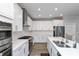 Modern kitchen with white cabinets, stainless steel appliances, and quartz countertops at 750 Keck Way, Westfield, IN 46074