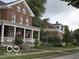 Two story brick houses with porches and American flags at 5736 Birtz Rd, Indianapolis, IN 46216