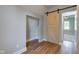 Bedroom with barn door, hardwood floors, and built-in shelving at 1131 S East St, Lebanon, IN 46052