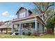 Gray craftsman home with white trim, front porch, and well-maintained landscaping at 3005 Broadway St, Indianapolis, IN 46205