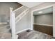 Spacious entryway with staircase, wood-look floors, and view to the living room at 3005 Broadway St, Indianapolis, IN 46205