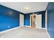 Blue bedroom with neutral carpeting and double doors at 3005 Broadway St, Indianapolis, IN 46205