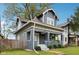 Renovated craftsman home with gray exterior, white trim, and a spacious front yard at 3005 Broadway St, Indianapolis, IN 46205