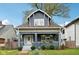 Charming craftsman home with gray exterior, white trim, and a landscaped lawn at 3005 Broadway St, Indianapolis, IN 46205