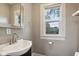 Updated bathroom with a vanity and a window at 3005 Broadway St, Indianapolis, IN 46205