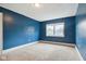 Blue bedroom with neutral carpeting and window at 3005 Broadway St, Indianapolis, IN 46205
