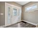 Bright entryway with white door, stained glass sidelights, and wood-look flooring at 3005 Broadway St, Indianapolis, IN 46205