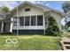 House exterior featuring a front porch and a well-maintained lawn at 1317 W Memorial Dr, Muncie, IN 47302