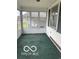 Enclosed porch with green carpeting at 1317 W Memorial Dr, Muncie, IN 47302