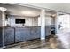 Open concept living room with gray sectional and hardwood floors at 13309 W Sr 32, Yorktown, IN 47396