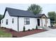 Modern farmhouse exterior with white brick and black roof at 2068 S Avon Ave, Avon, IN 46123