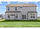 Two-story house with gray siding, multiple windows, and a backyard at 10620 Banyan Wood Ct, Indianapolis, IN 46239