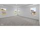 Bright bedroom with carpet flooring and large windows offering backyard views at 10620 Banyan Wood Ct, Indianapolis, IN 46239