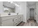 Modern bathroom with dual vanity, a shower, and walk-in closet at 10620 Banyan Wood Ct, Indianapolis, IN 46239