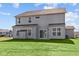 Two-story house with gray siding, multiple windows, and a backyard at 10620 Banyan Wood Ct, Indianapolis, IN 46239