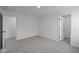 Simple bedroom with grey carpet and doors to a closet and another room at 10620 Banyan Wood Ct, Indianapolis, IN 46239